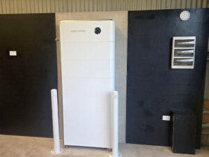 A Sigenergy SigenStor energy storage system with protective bollards and electrical sub-board.